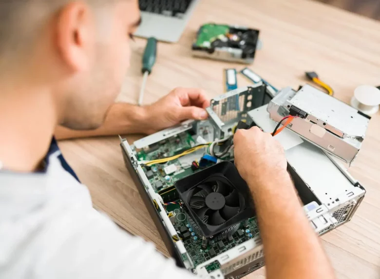top-view-hispanic-technician-fixing-computer-fan-young-man-connecting-new-component-part-cpu_1_